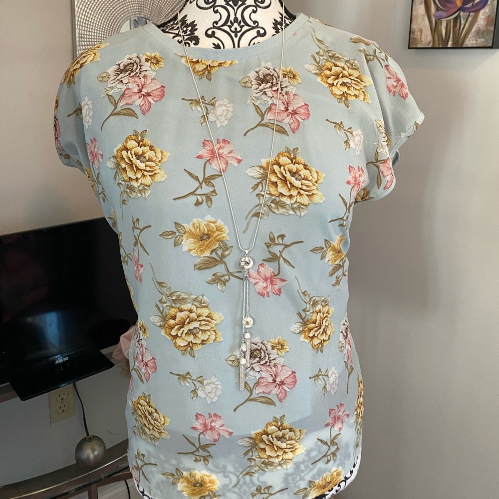 Sheer flowered shirt.
